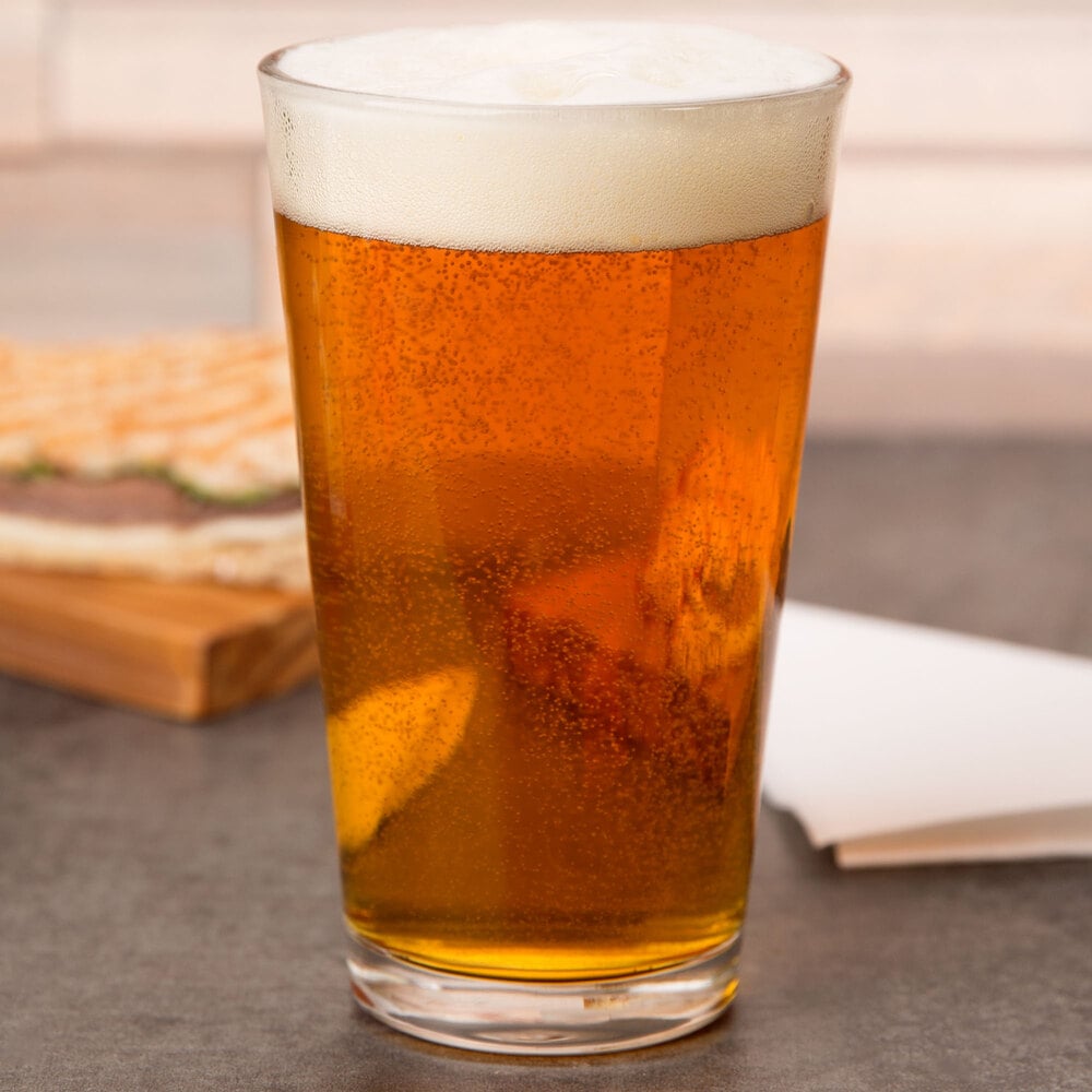 Pint glass filled with amber-colored beer