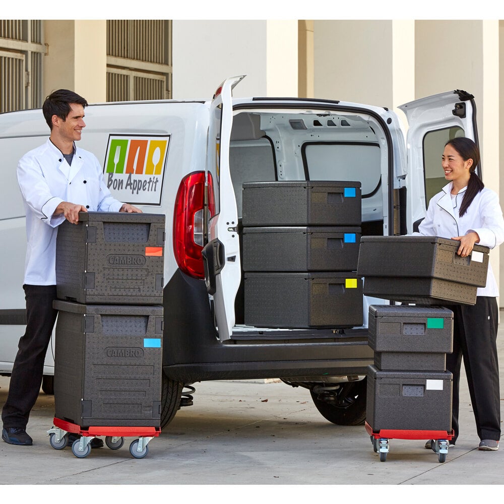 Cam GoBoxes stacked inside and outside a delivery van with 2 workers moving them
