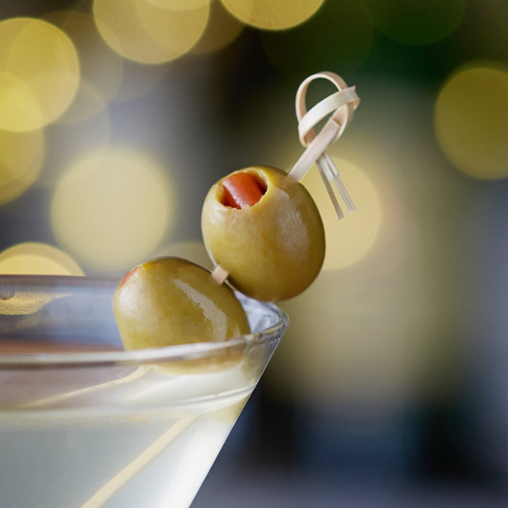 Two queen olives garnishing a martini