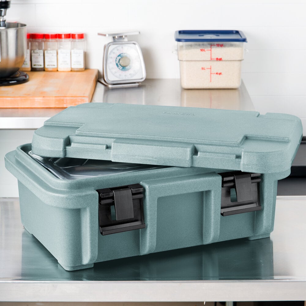 Cambro slate blue CamCarrier with lid sitting on top and a food pan inside