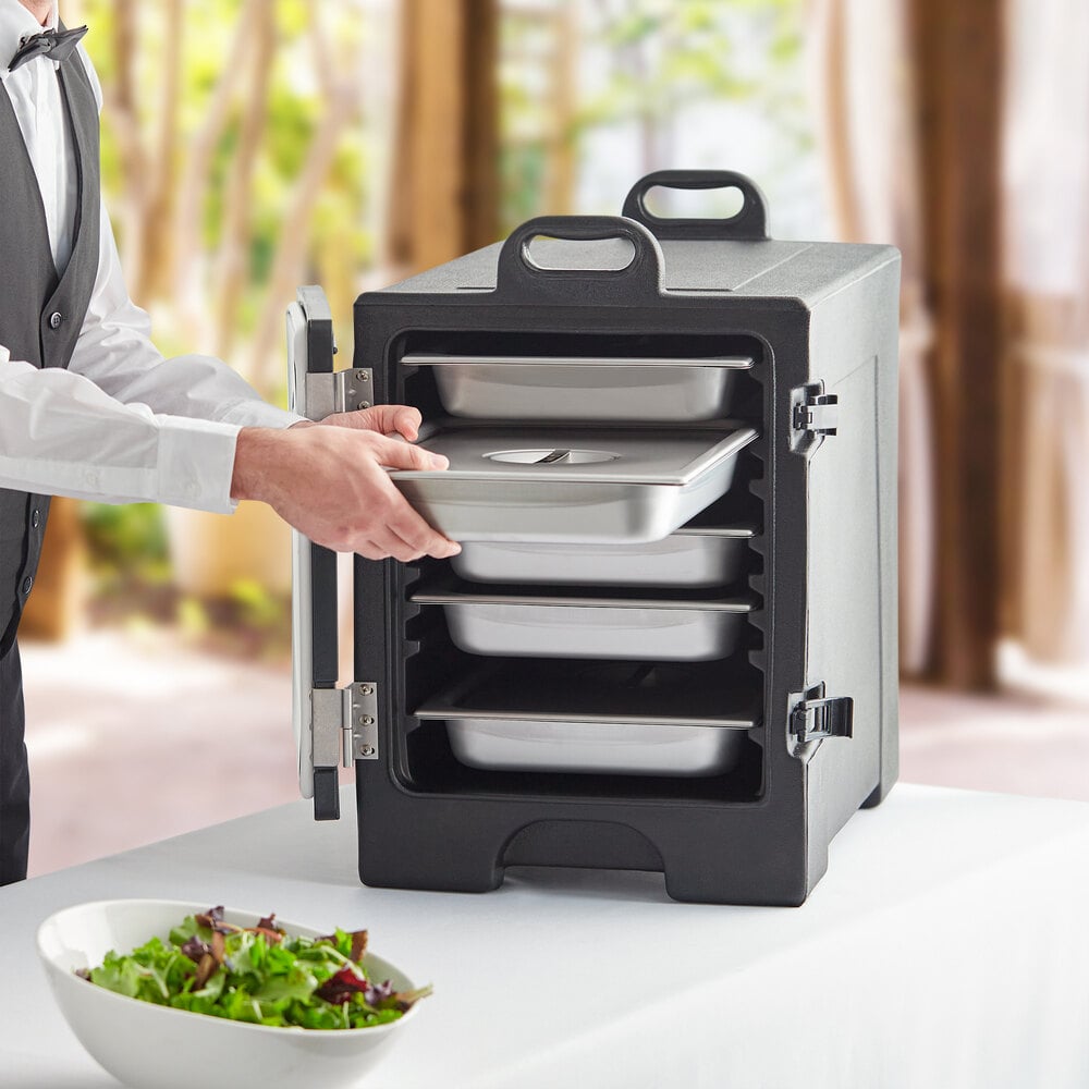 A server placing a food pan in a CaterGator food pan carrier