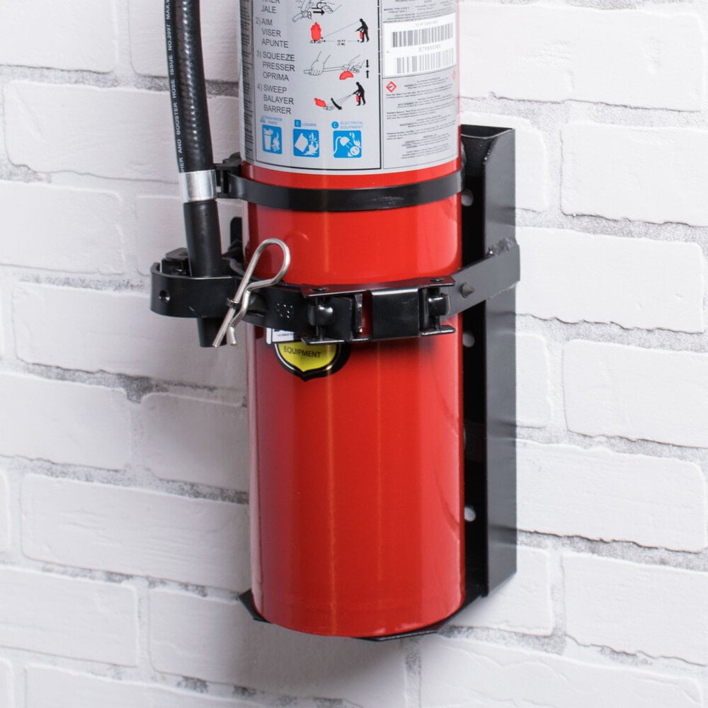 Bottom half of red Buckeye fire extinguisher mounted in black bracket on white wall