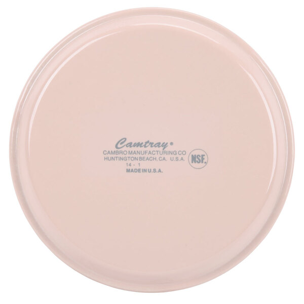 A light peach Cambro round fiberglass tray with a label.
