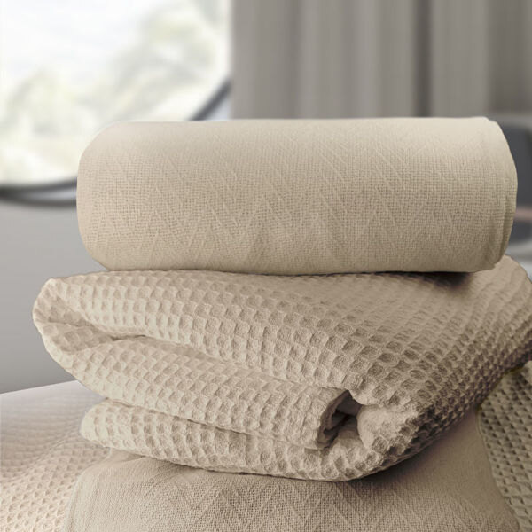 A stack of Oxford beige herringbone blankets.