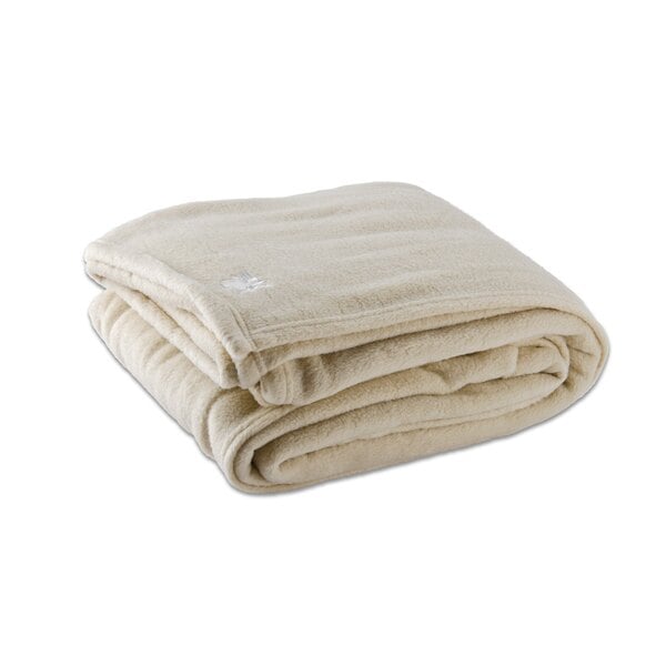 A folded Oxford vanilla fleece hotel blanket on a white surface.