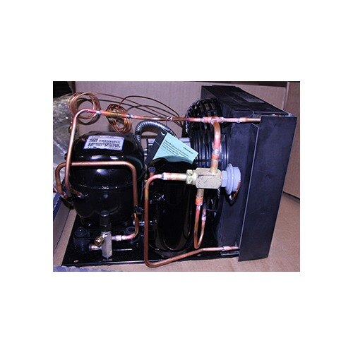 A True condensing unit with copper pipes and a valve.