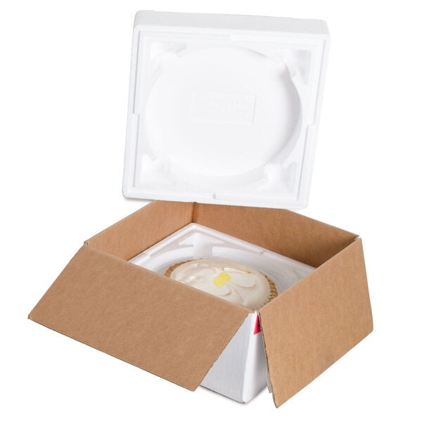 A white foam box with a round pie inside.