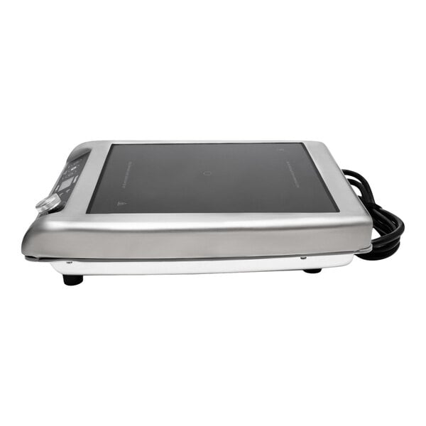 A stainless steel countertop induction range with a black glass cooking surface and control panel, featuring a coiled power cord.