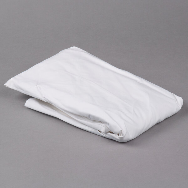 A folded white Oxford T300 Super Deluxe fitted sheet on a gray surface.