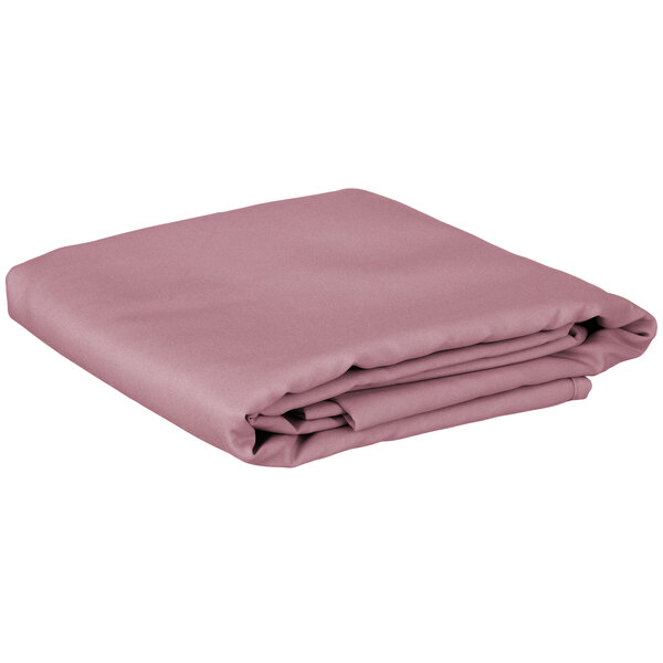 A folded pink table cover on a white background.