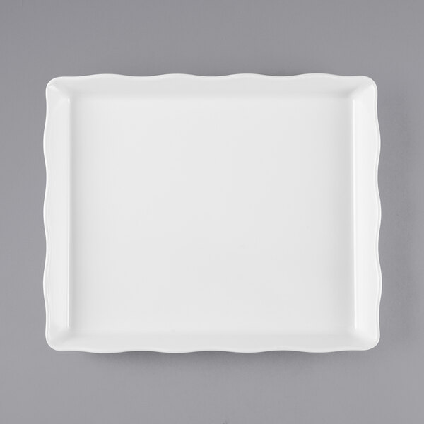 A white rectangular tray with a scalloped edge.