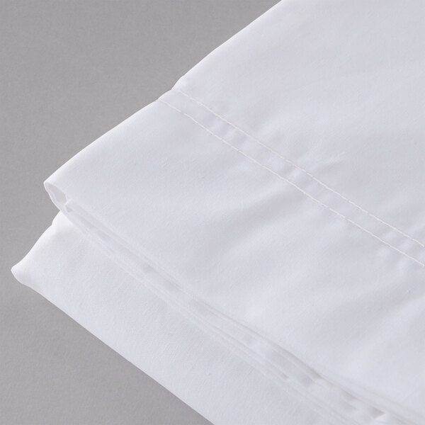 A close up of a white Oxford T300 Super Deluxe XL queen size flat sheet.