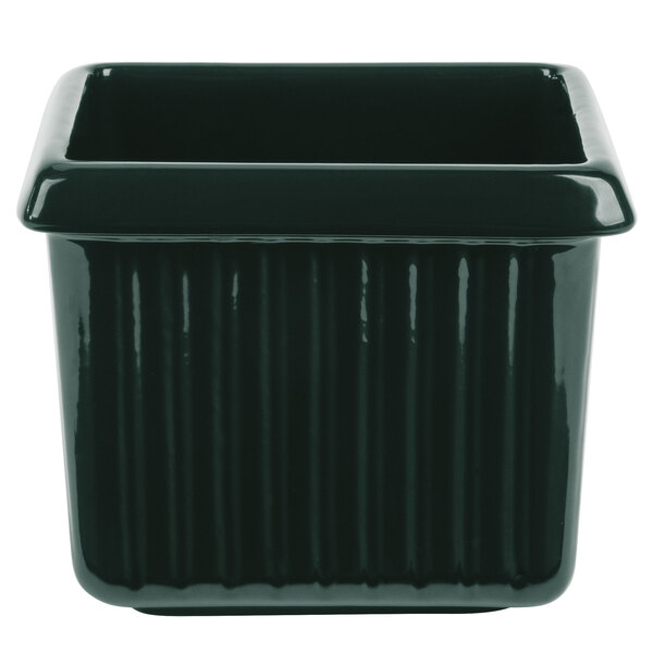 A black rectangular pot with ridges on the counter in a salad bar.