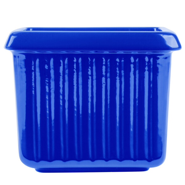 A cobalt blue rectangular cast aluminum server with ridges.