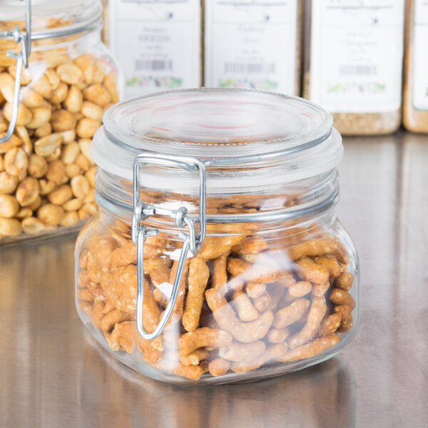 Two Libbey glass jars filled with peanuts with clamp lids.