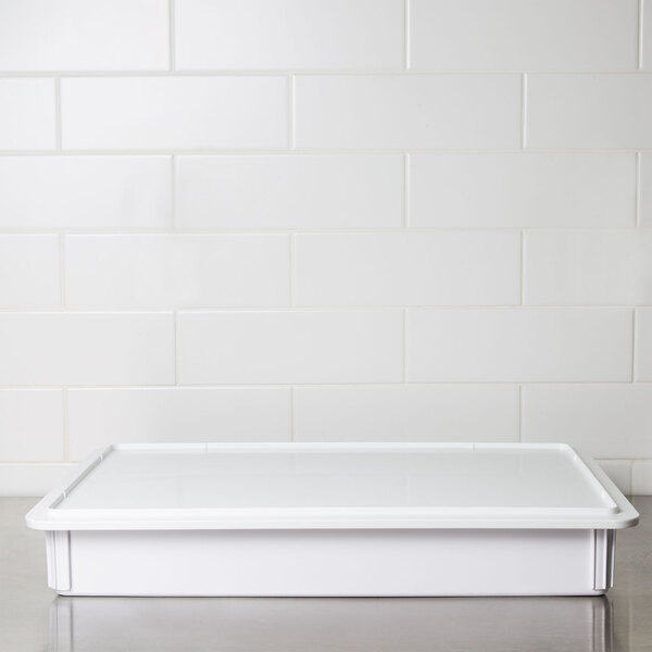 An American Metalcraft white rectangular ABS plastic dough box on a stainless steel counter.