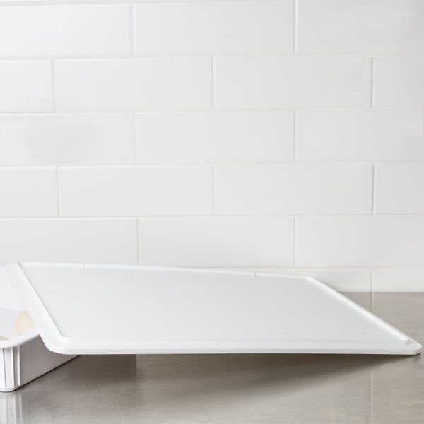 An American Metalcraft white ABS plastic cover for a standard dough box on a counter.