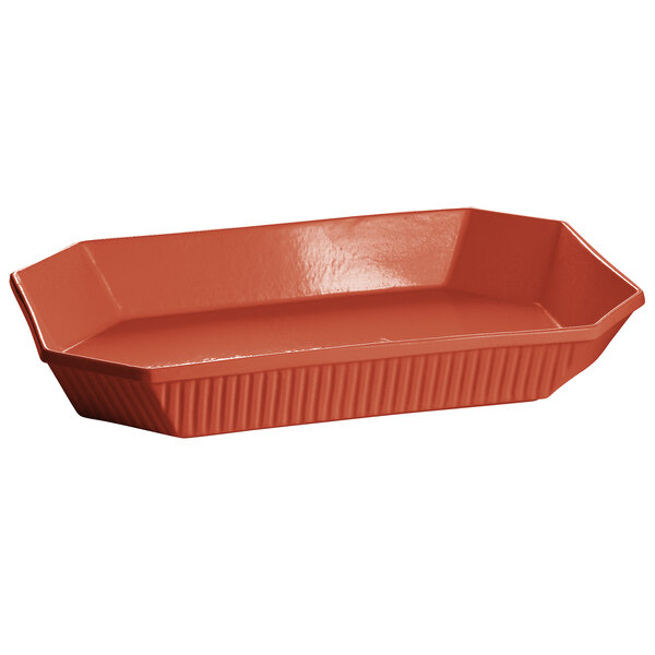 A copper octagon casserole dish with a lid and handles.