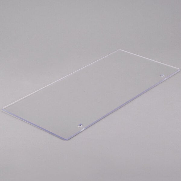 A clear rectangular plastic panel with a small hole in it.