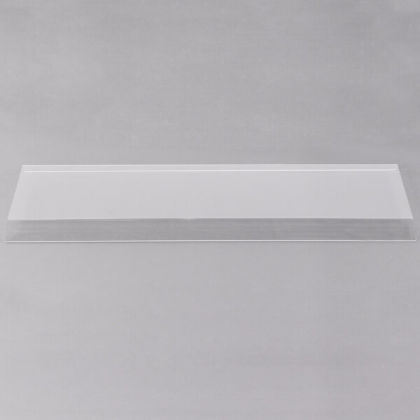 A clear rectangular object on a white surface.