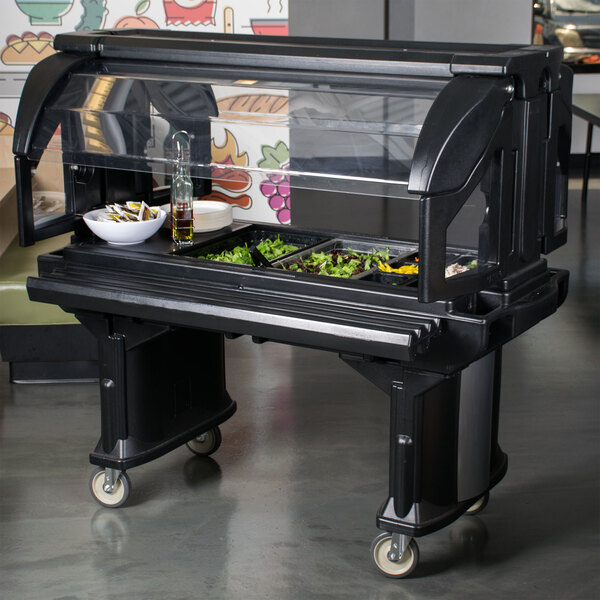 A black and white food buffet with a Cambro Sneeze Guard on it.