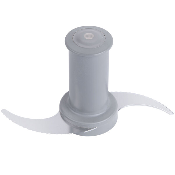 A stainless steel bowl with a grey food processor blade inside.