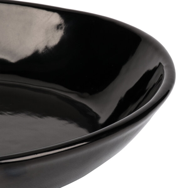A close-up of a black Tablecraft open handle skillet.
