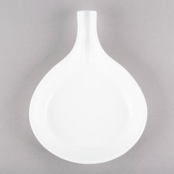 A white cast aluminum skillet with an open handle.