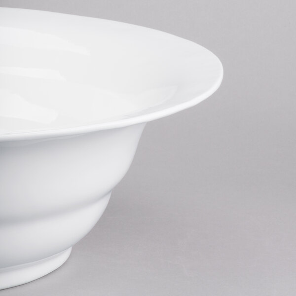 A close-up of a Tablecraft white cast aluminum wide rim salad bowl.