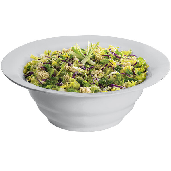 A Tablecraft natural cast aluminum salad bowl filled with lettuce and celery.