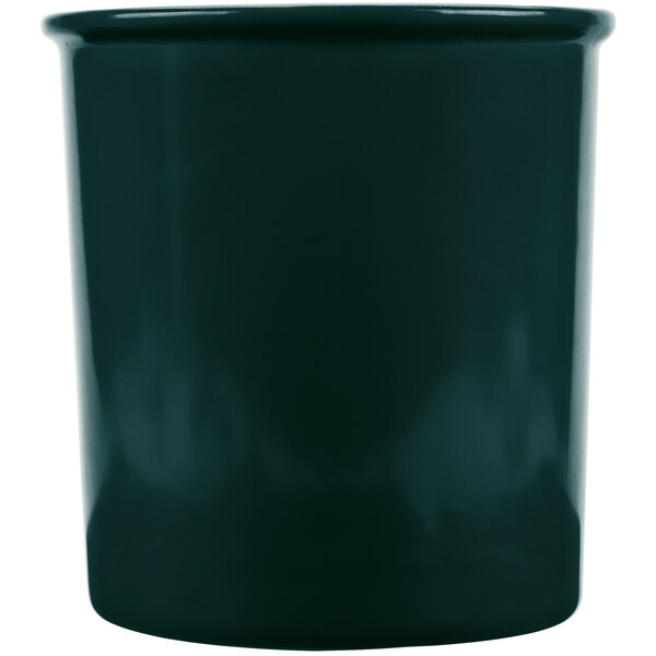 A hunter green cast aluminum salad dressing bowl.