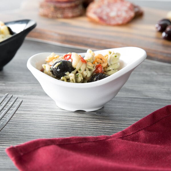 A Tablecraft white melamine bowl with pasta, olives, and tomatoes.