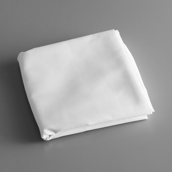 A folded white Intedge rectangular tablecloth on a white surface.