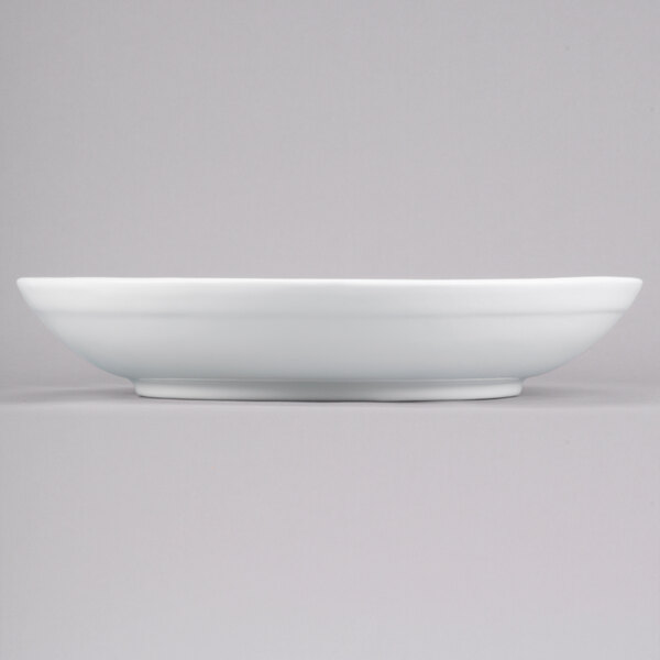 A white Tablecraft cast aluminum pasta bowl on a gray surface.
