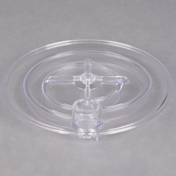A clear plastic dish with a circular hole in it.