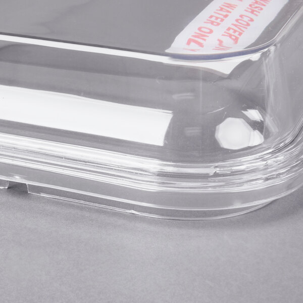 A clear plastic lid on a Grindmaster Cecilware refrigerated beverage dispenser bowl.