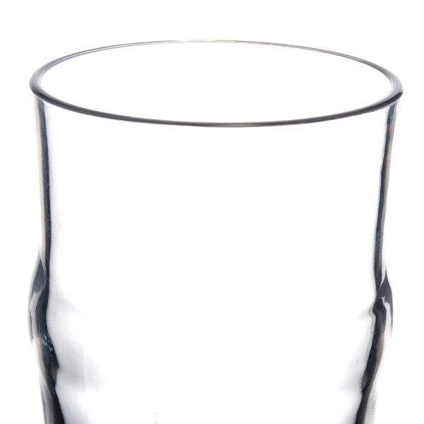 A close up of a clear plastic Thunder Group English Pub glass.