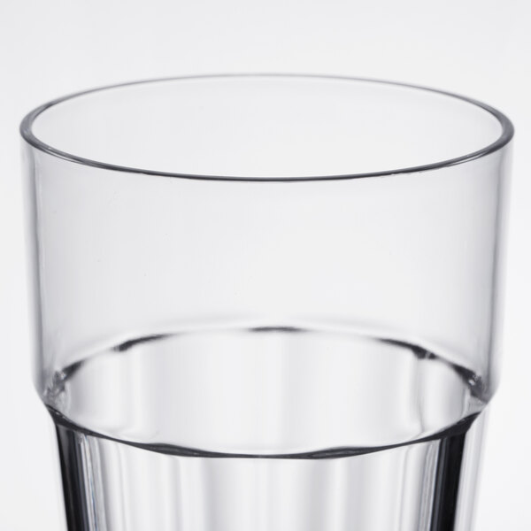 A close-up of a Thunder Group clear polycarbonate tumbler full of water.