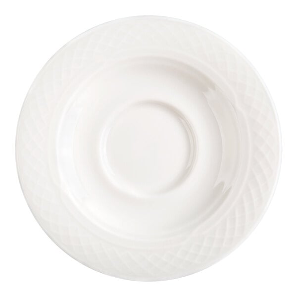 A round, white saucer with a subtle textured pattern around the rim and a central indentation for holding a cup.
