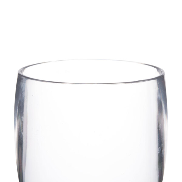 A close-up of a clear Thunder Group plastic pilsner glass.