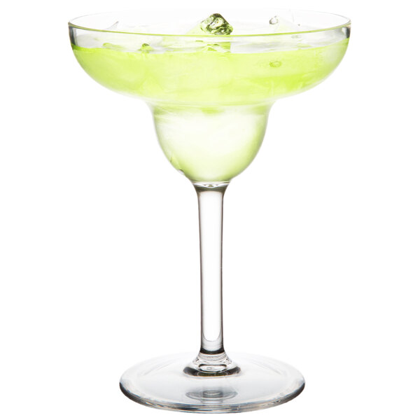 A Thunder Group plastic margarita glass filled with a green margarita, garnished with lime.