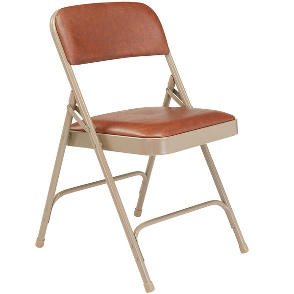 A National Public Seating beige metal folding chair with a honey brown vinyl padded seat.