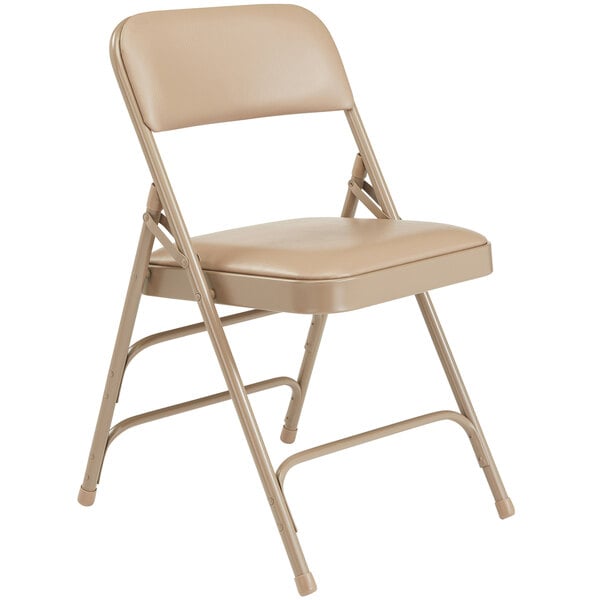 A beige National Public Seating metal folding chair with a French beige vinyl padded seat.