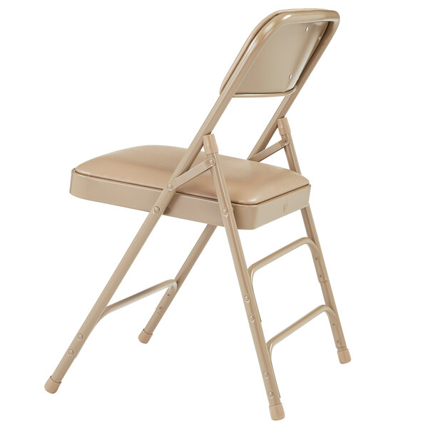 A National Public Seating beige metal folding chair with a French beige vinyl padded seat.