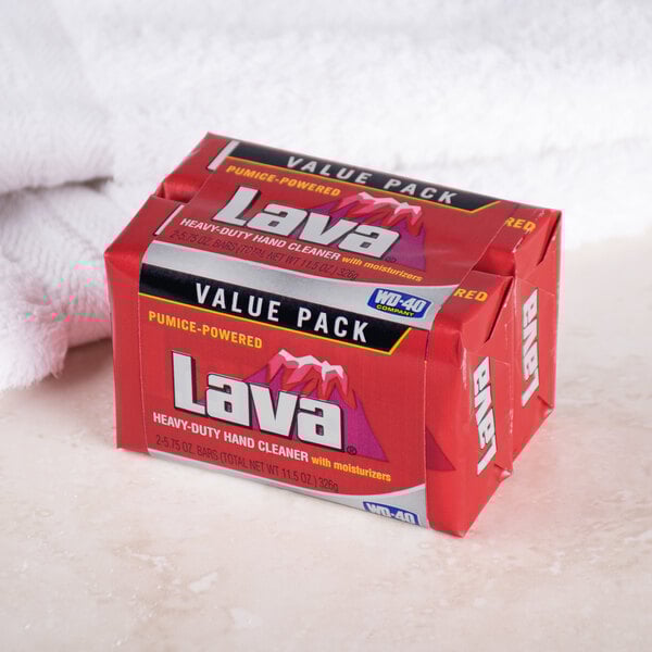 A red package of Lava bar soap on a white towel.