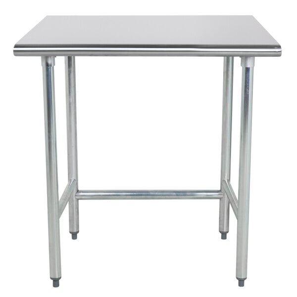 An Advance Tabco stainless steel work table with metal legs.