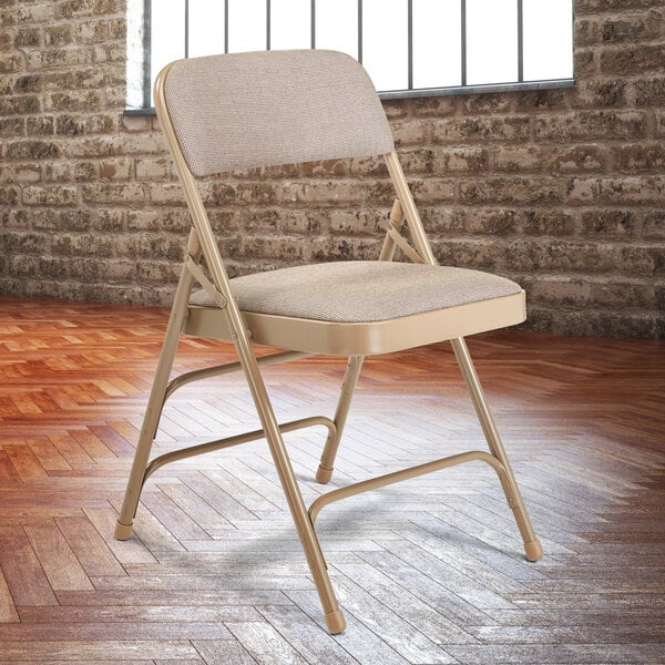 A beige National Public Seating metal folding chair with a padded seat.