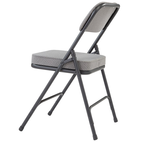 A black metal National Public Seating folding chair with a charcoal gray cushion.