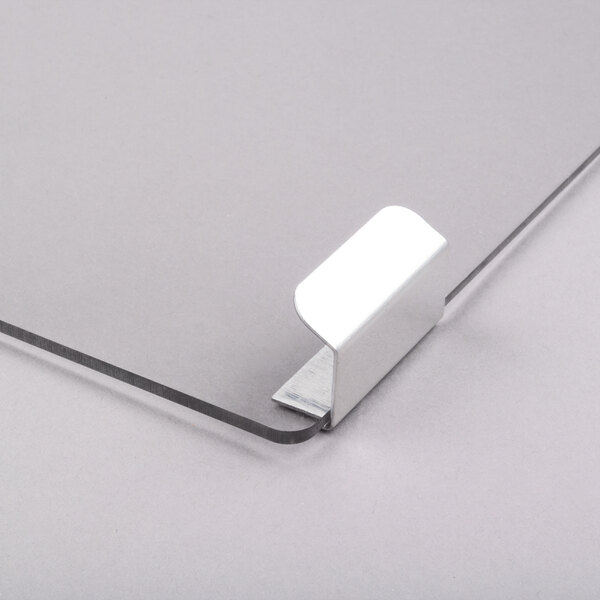 A silver metal door clip for a Paragon Simply-A-Blast snow cone machine.