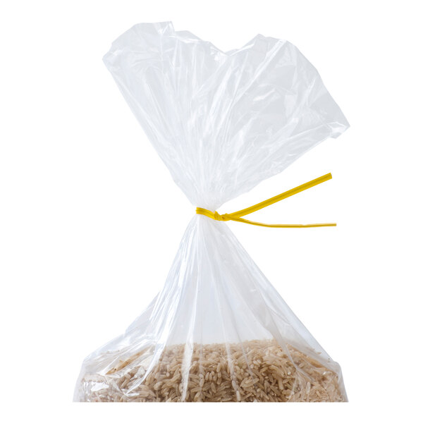 A clear plastic bag containing rice is sealed with a yellow twist tie.